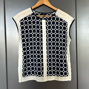 Navy/white sleeveless blouse.